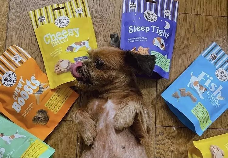 Small dog with dog treat bags | Laughing Dog Food