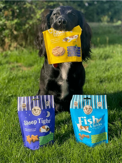 Dog with dog treats on grass | Laughing Dog Food