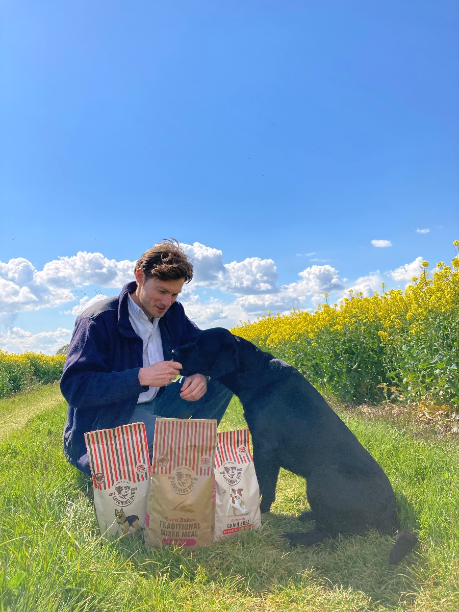 Dog and man in field with dog food | Laughing Dog Food