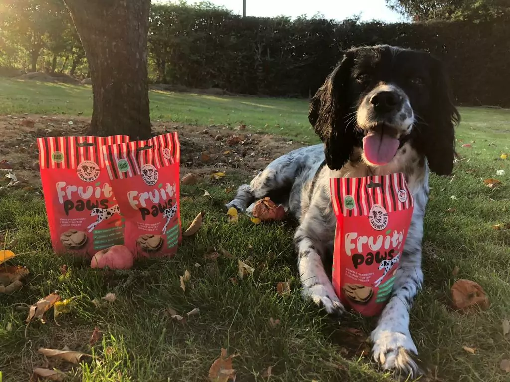 Dog on grass with treat bag | Laughing Dog Food